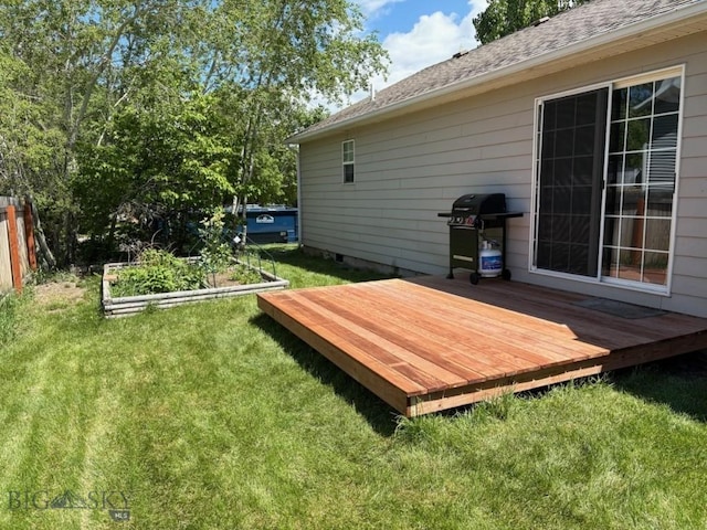 303 Treasure, Bozeman, MT 59718 - view of grassy yard with a deck and a vegetable garden