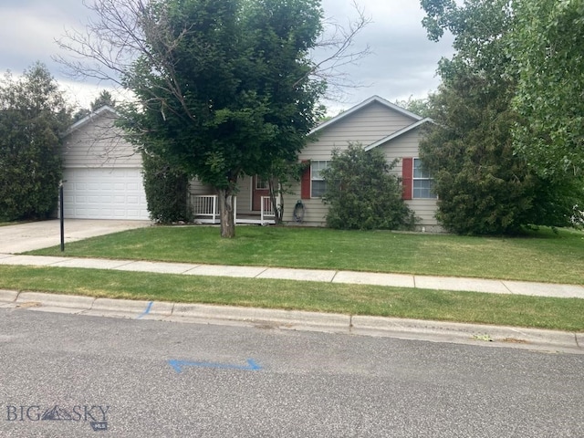 303 Treasure, Bozeman, MT 59718 - obstructed view of property featuring concrete driveway, a front lawn, and an attached garage