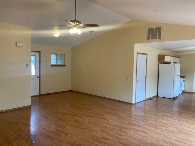 303 Treasure, Bozeman, MT 59718 - unfurnished living room featuring vaulted ceiling, wood finished floors, and ceiling fan