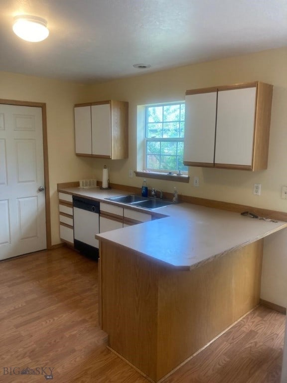 303 Treasure, Bozeman, MT 59718 - kitchen with white dishwasher, a peninsula, light wood-style flooring, and white cabinets