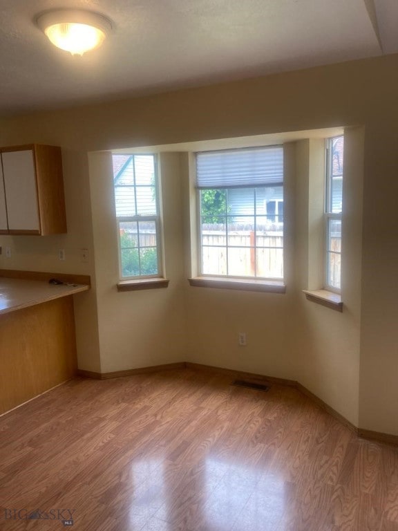 303 Treasure, Bozeman, MT 59718 - unfurnished dining area with light wood-style floors and baseboards