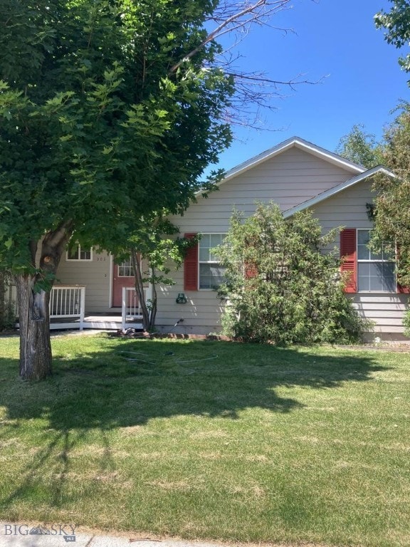 303 Treasure, Bozeman, MT 59718 - obstructed view of property featuring a front lawn