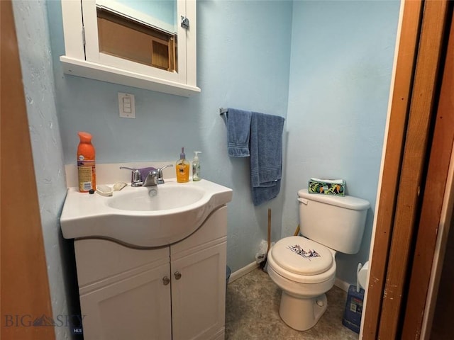 105 Country Club Ln, Butte, MT 59701 - bathroom featuring toilet, vanity, and baseboards