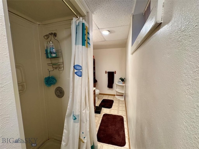 105 Country Club Ln, Butte, MT 59701 - full bathroom with a stall shower, toilet, and a paneled ceiling