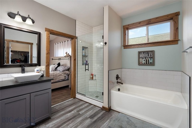317 Shelter Grv, Bozeman, MT 59718 - bathroom featuring wood finished floors, plenty of natural light, a shower stall, and a garden tub