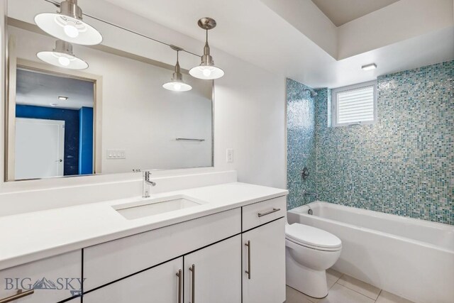 bathroom featuring toilet, tile patterned flooring, bathing tub / shower combination, and vanity