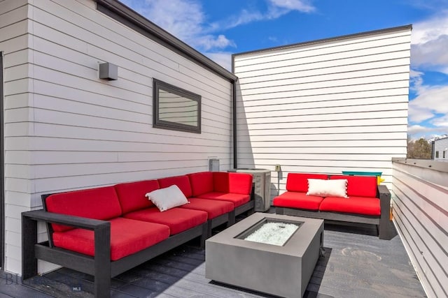 wooden deck with an outdoor living space with a fire pit