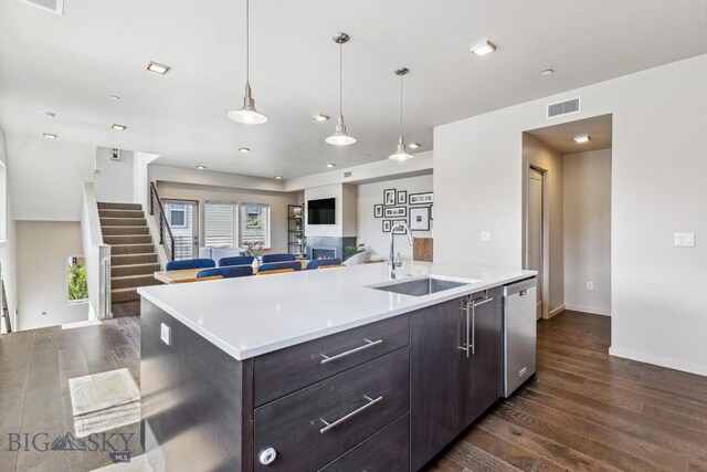 kitchen featuring a sink, open floor plan, dark wood-type flooring, and dishwasher