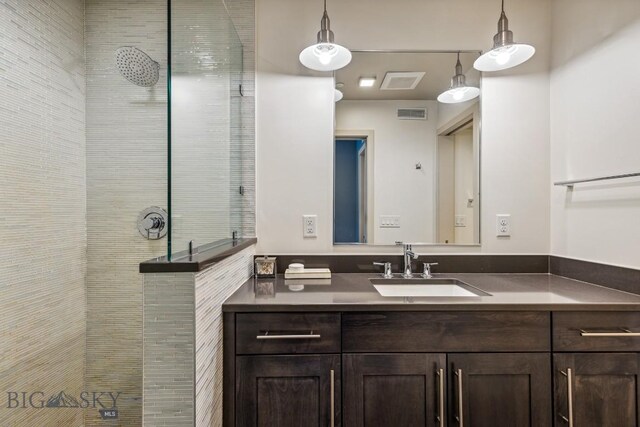 full bath featuring a walk in shower and vanity