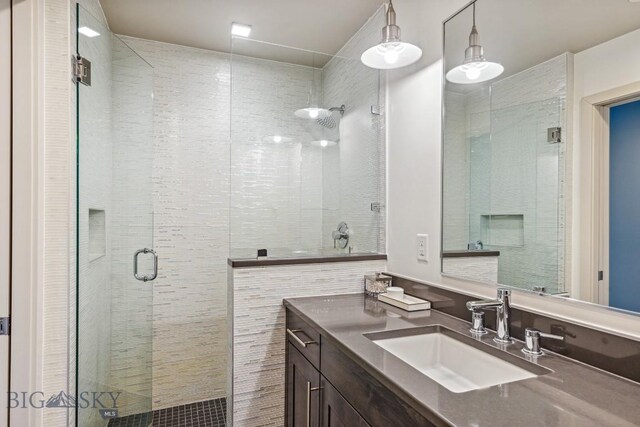 full bathroom with a stall shower and vanity