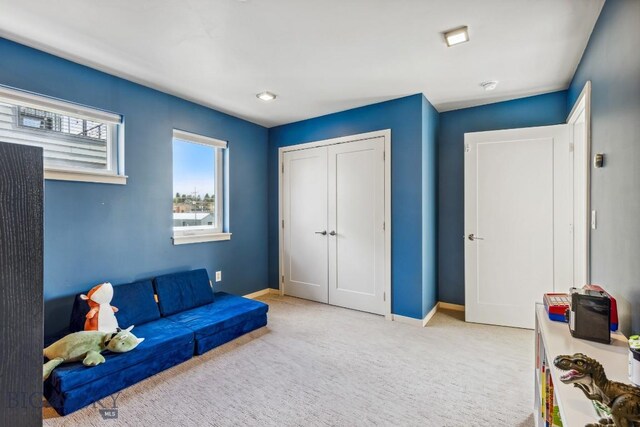 rec room featuring carpet and baseboards