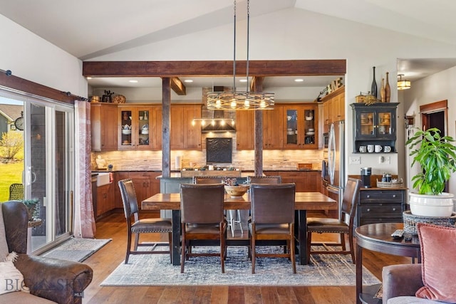 dining space with vaulted ceiling, dark wood-style flooring, and recessed lighting