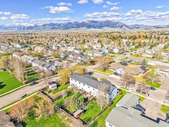 aerial view of property's location featuring a mountain backdrop and nearby suburban area