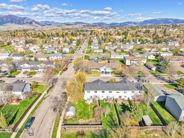 aerial overview of property's location featuring a mountainous background and nearby suburban area