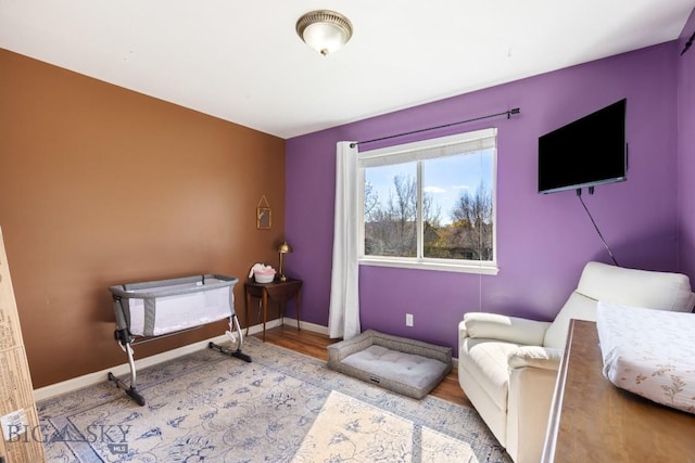 sitting room with wood finished floors and baseboards