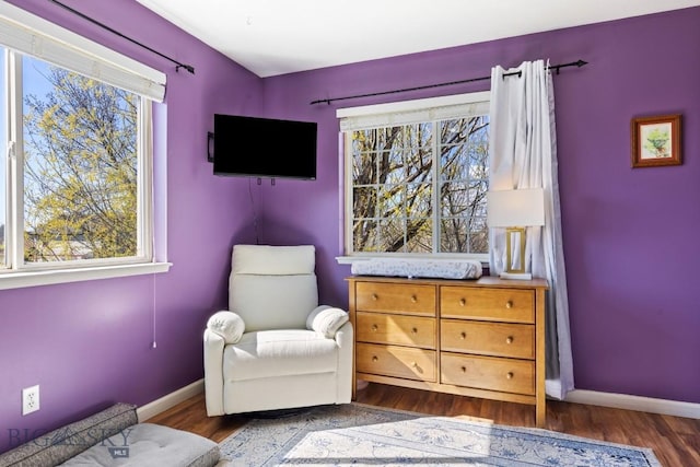 sitting room with plenty of natural light, baseboards, and wood finished floors