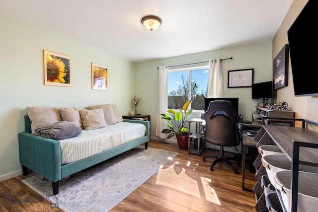 bedroom featuring a desk and wood finished floors