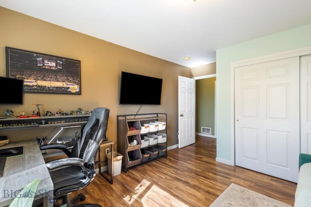office space featuring wood finished floors and baseboards