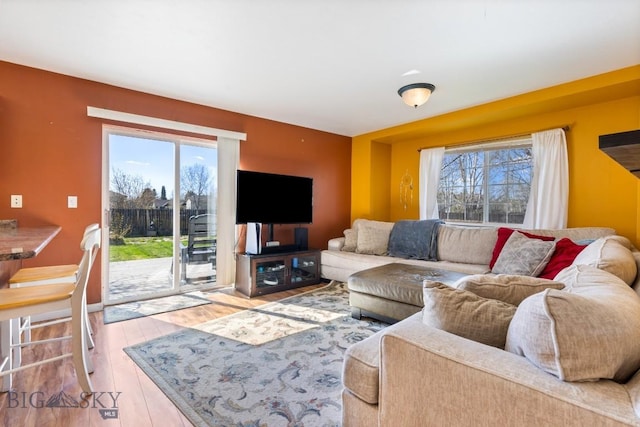 living room with plenty of natural light and wood finished floors