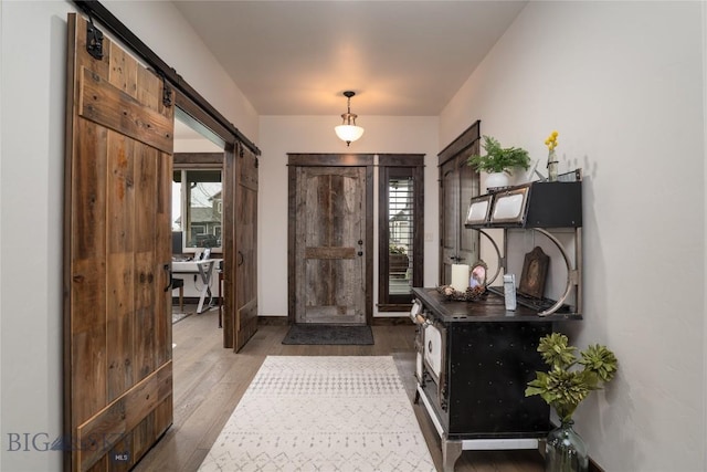 foyer entrance featuring wood finished floors and a barn door