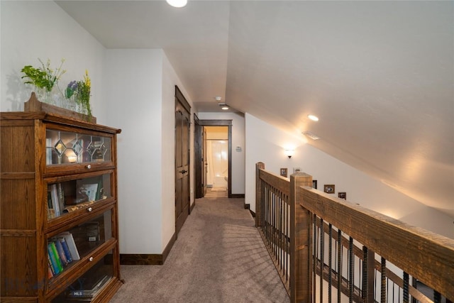 hall with vaulted ceiling, carpet floors, baseboards, an upstairs landing, and recessed lighting