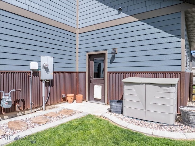 entrance to property featuring fence and a garage