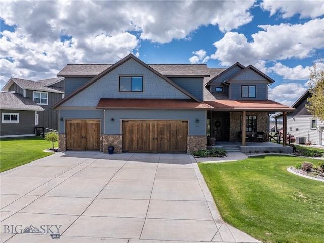 craftsman house with driveway, covered porch, a front yard, and central air condition unit
