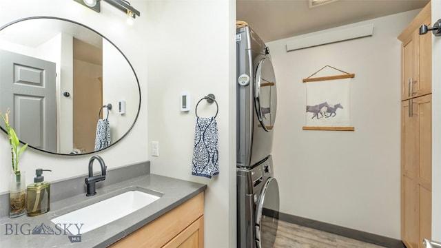 2200 Sugarloaf Mountain Rd, Glen, MT 59732 - bathroom with estacked washer and dryer, vanity, and wood finished floors