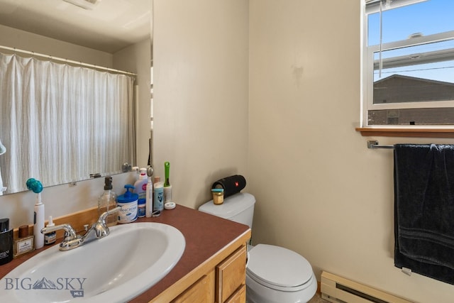 500/502 Idaho St, Belgrade, MT 59714 - bathroom featuring toilet, vanity, baseboard heating, and a shower with shower curtain