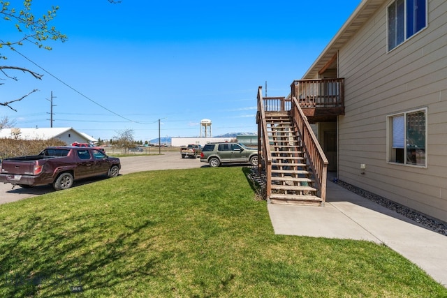 500/502 Idaho St, Belgrade, MT 59714 - view of grassy yard featuring stairway and a wooden deck