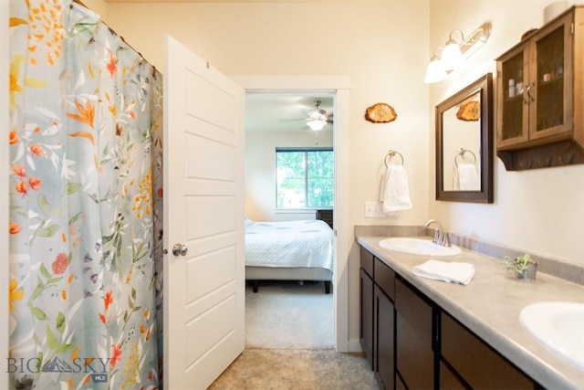 ensuite bathroom featuring double vanity and a shower with shower curtain