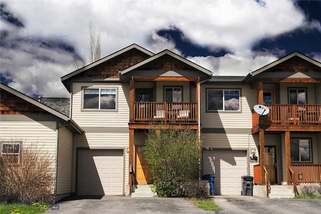 view of front facade featuring a balcony, a garage, and driveway