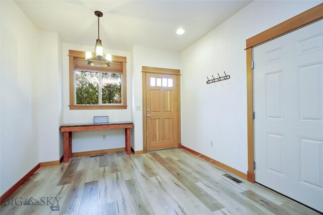 entryway featuring light wood-style floors, baseboards, and recessed lighting