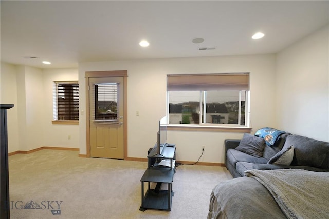 living area with light carpet, recessed lighting, and baseboards