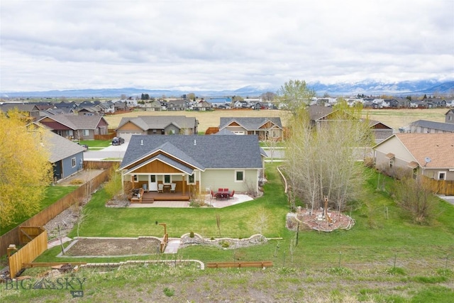 back of property with a residential view and a patio area