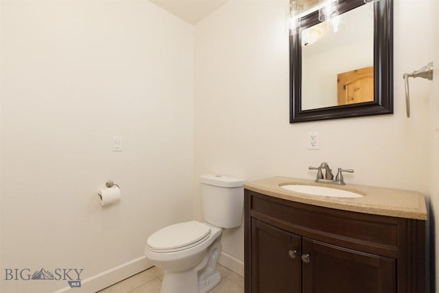 half bath with baseboards, tile patterned flooring, toilet, and vanity
