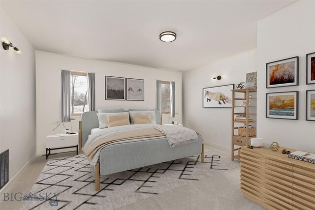 bedroom with light colored carpet and baseboards