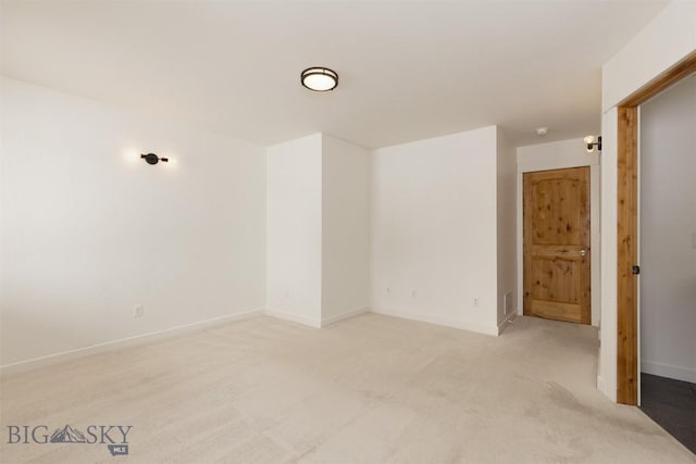 empty room with light carpet and baseboards