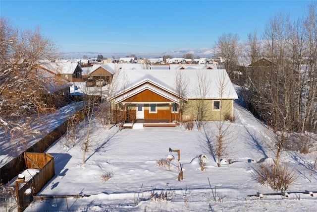 view of snow covered rear of property