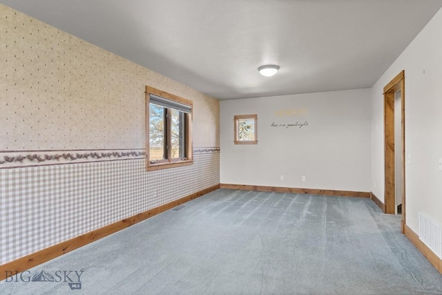 3450 W Hollyhock Dr, Belgrade, MT 59714 - spare room featuring wallpapered walls, baseboards, carpet floors, and wainscoting