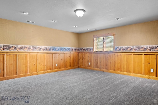 3450 W Hollyhock Dr, Belgrade, MT 59714 - unfurnished room featuring carpet flooring, wainscoting, and wooden walls