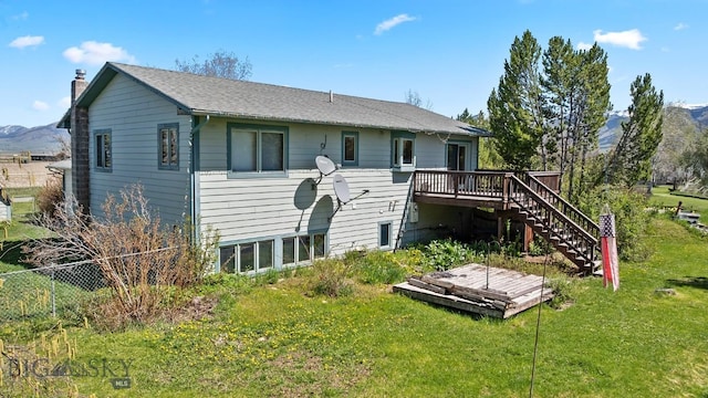 3450 W Hollyhock Dr, Belgrade, MT 59714 - rear view of property with a deck with mountain view, stairs, and a chimney