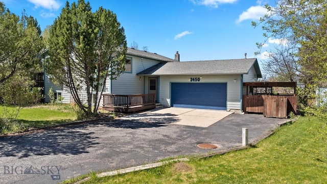 3450 W Hollyhock Dr, Belgrade, MT 59714 - split level home with driveway, a garage, a chimney, and a wooden deck