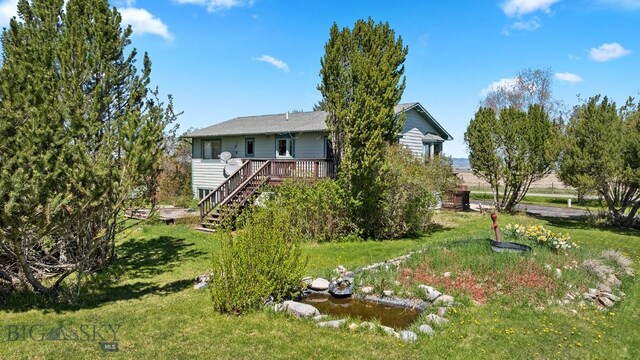 3450 W Hollyhock Dr, Belgrade, MT 59714 - back of house featuring a yard, a deck, and stairs