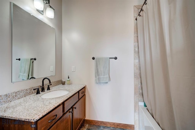 full bathroom featuring vanity, shower / bathtub combination with curtain, and baseboards