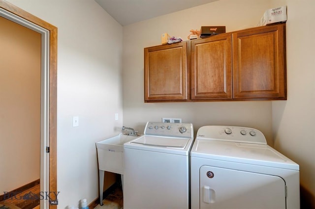 laundry room with washer and clothes dryer and cabinet space