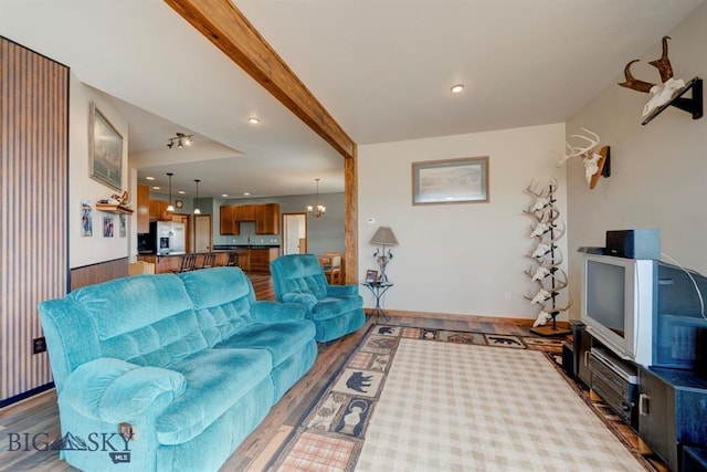 living room with wood finished floors, baseboards, and recessed lighting