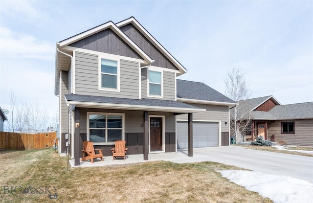 view of front of home featuring driveway, board and batten siding, and a garage