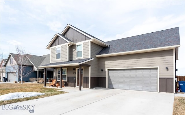 craftsman inspired home featuring board and batten siding, driveway, a garage, and a porch