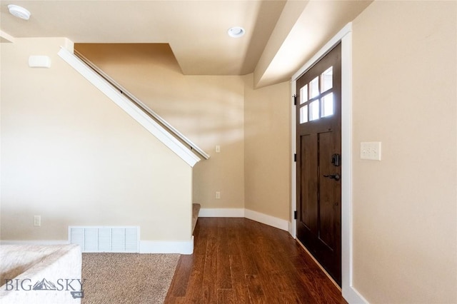 foyer with wood finished floors, baseboards, stairway, and recessed lighting